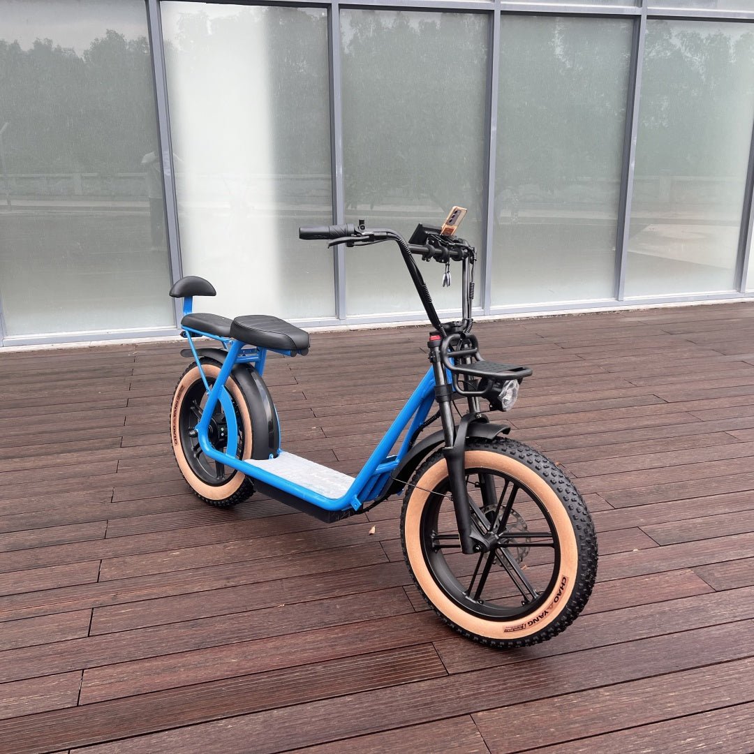 Blue AS202 Electric Scooter with tan off-road tires and upgraded fork, parked on a wooden deck for outdoor use.